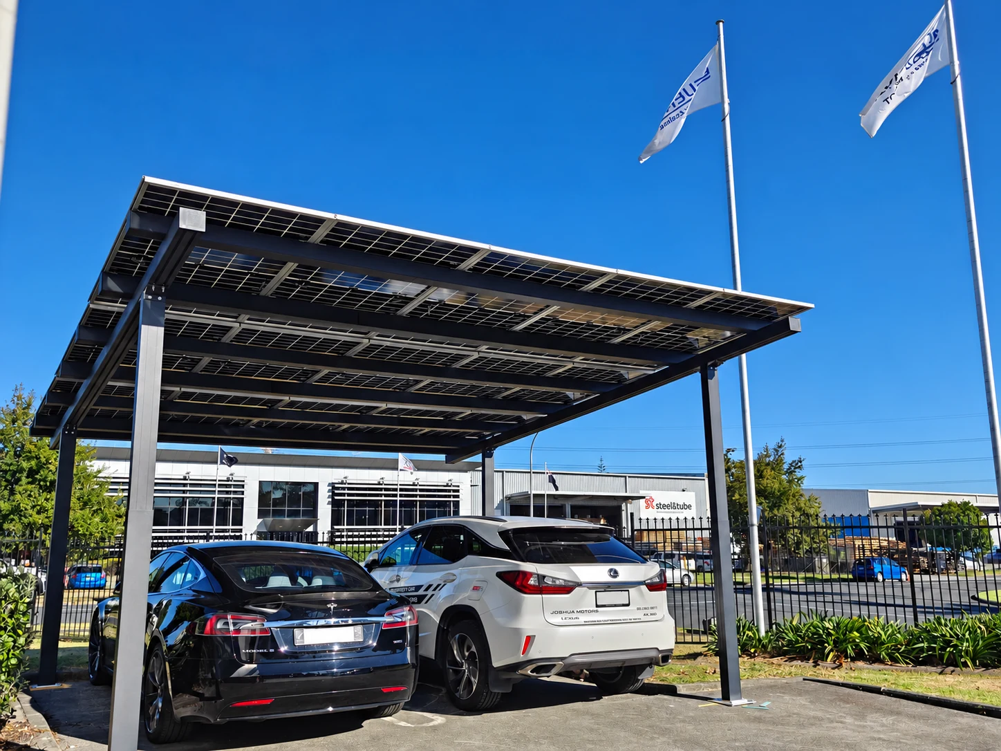 Two vehicles beneath the solar canopy.