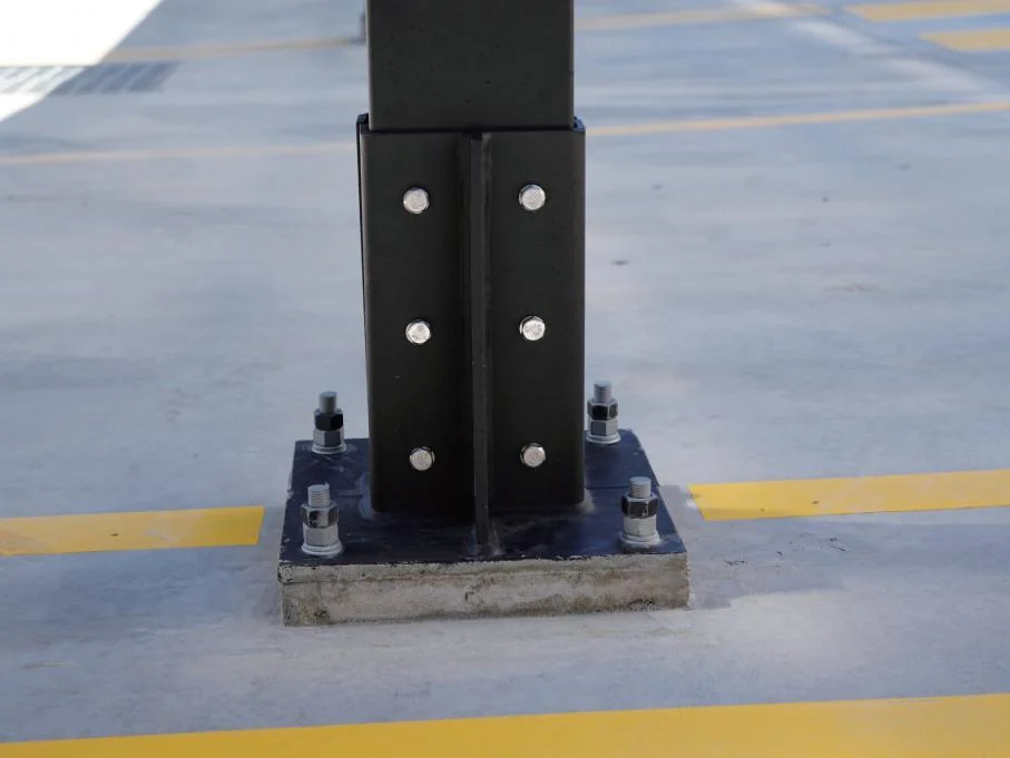 Bolted STRIX steel column base installed on a concrete footing