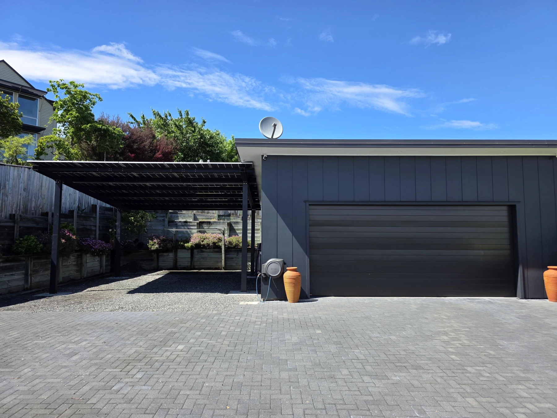 The completed carport beside the existing garage.