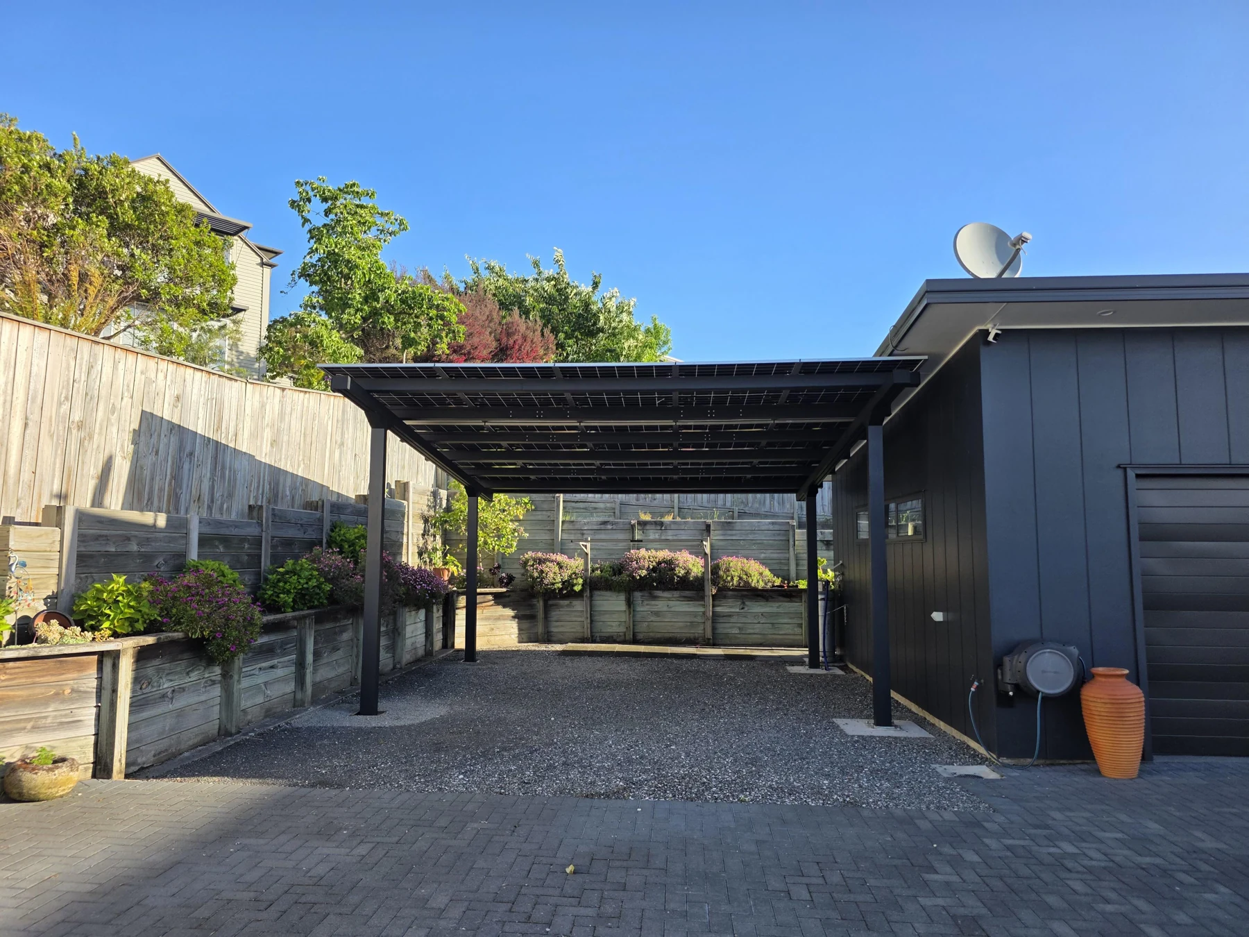The open double parking space beneath the solar roof.